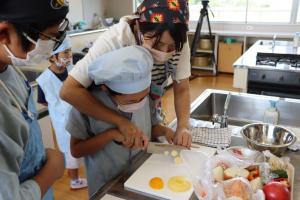 包丁で野菜を切る親子