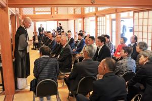 本堂で住職がお話をする様子