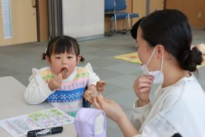蒸しパンを試食する子どもの写真