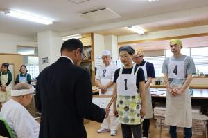 認定証を渡している末宗代表と受け取っている受験者の写真