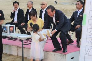 賞品を渡している佐々木市長と受け取る当選者の写真